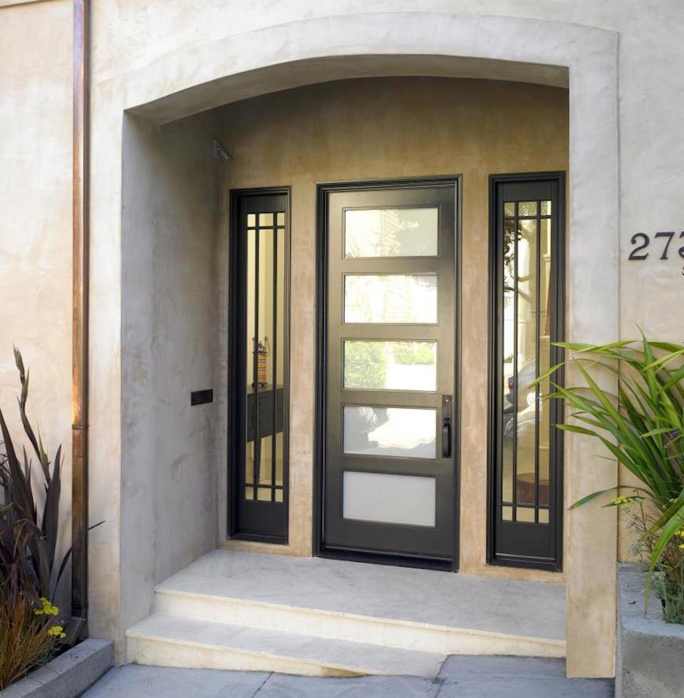 Black front door with opaque glass panels and two sidelites with clear glass.