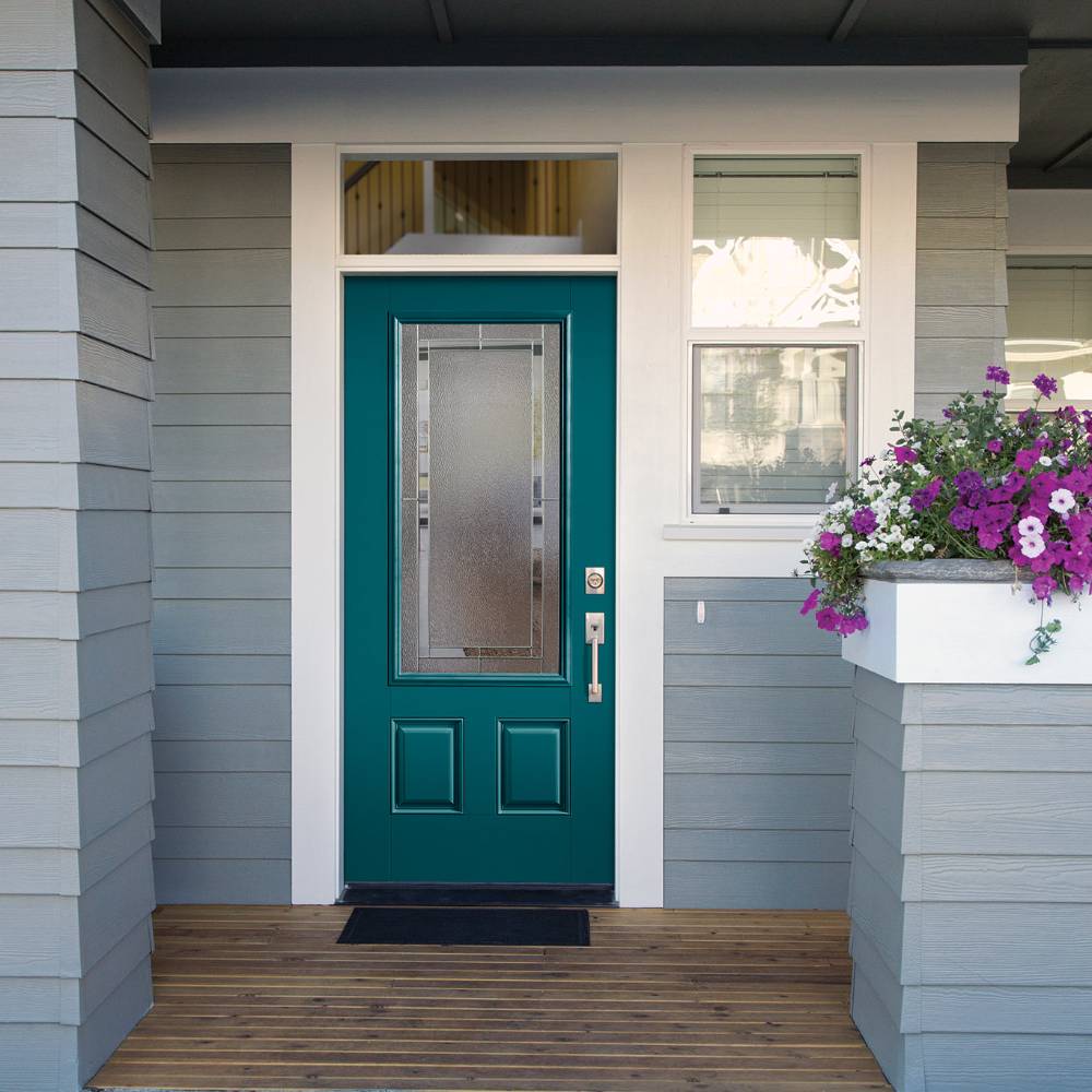 Teal front door with decorative privacy glass on gray house.