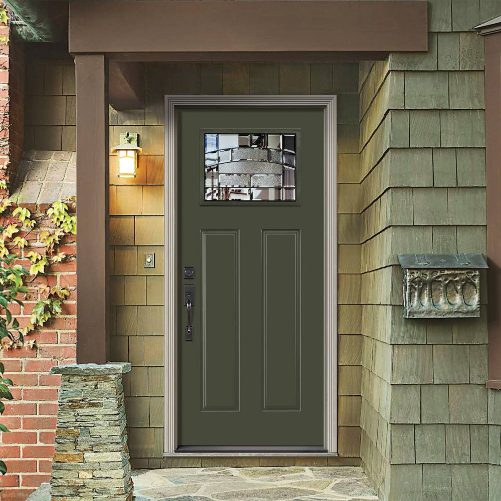 Moss green front door with dark hardware and decorative glass.