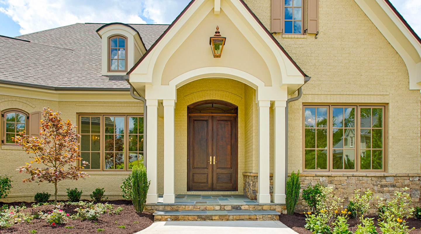 Beautiful single-family home with wood front doors. 