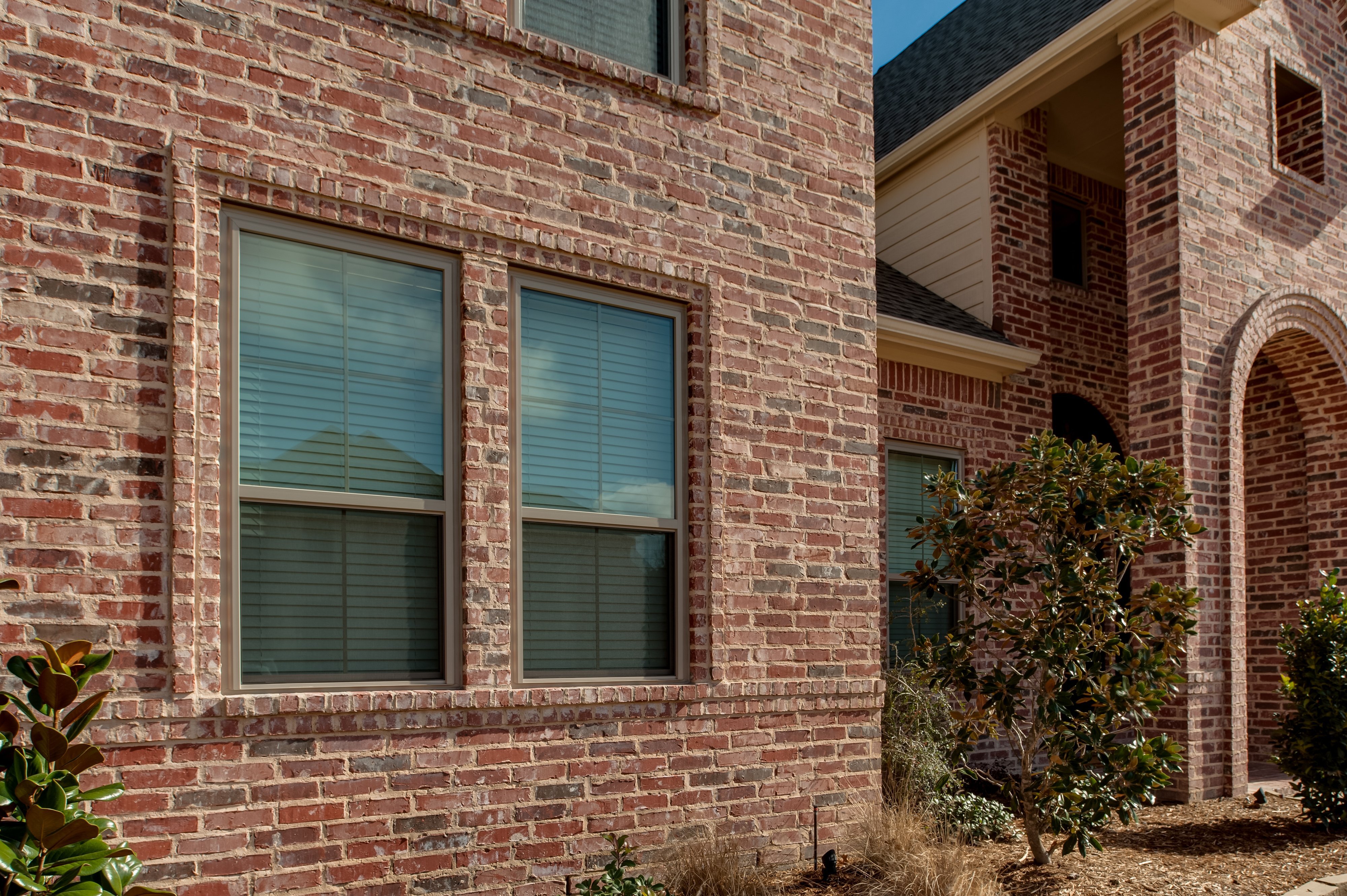 Two side-by-side Brennan Traditions single hung window in clay.