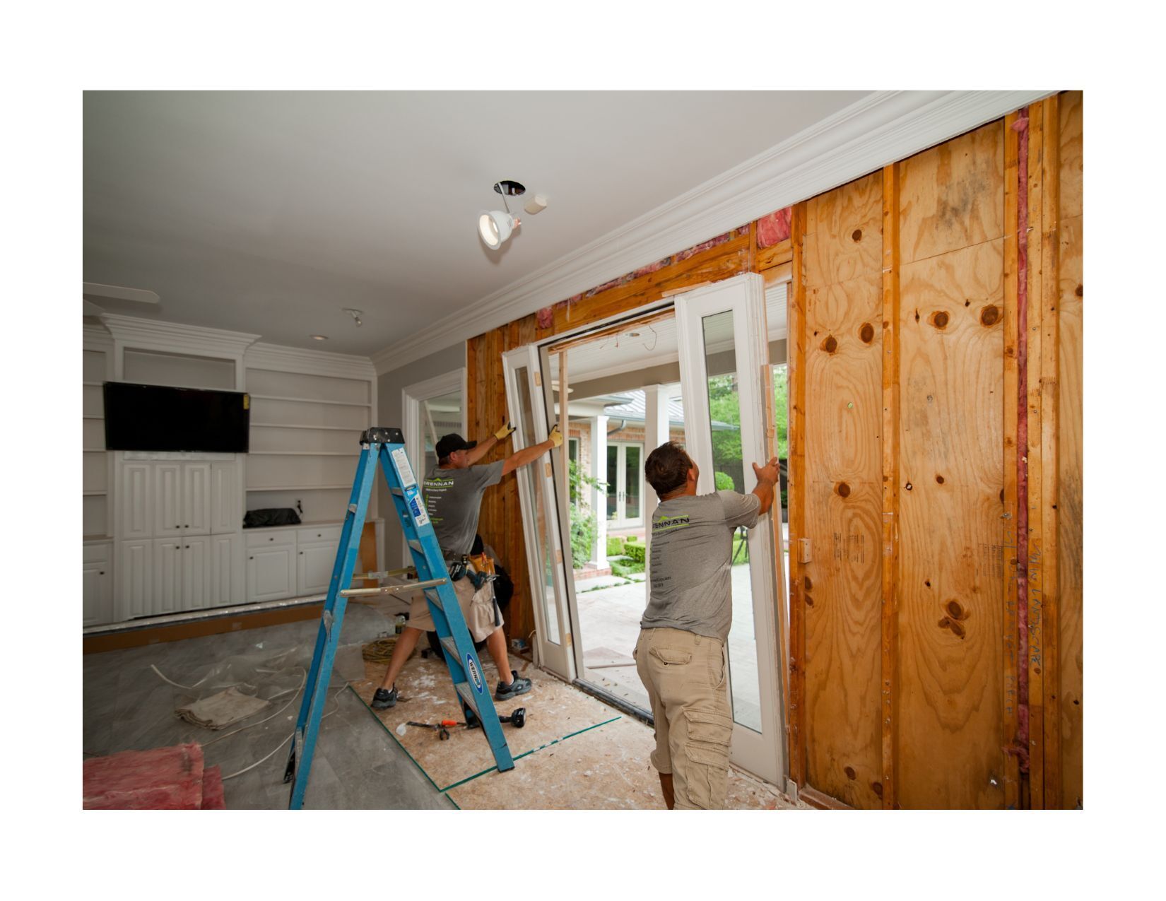 Brennan installers removing the existing doorframe to replace it with a new doorframe and door