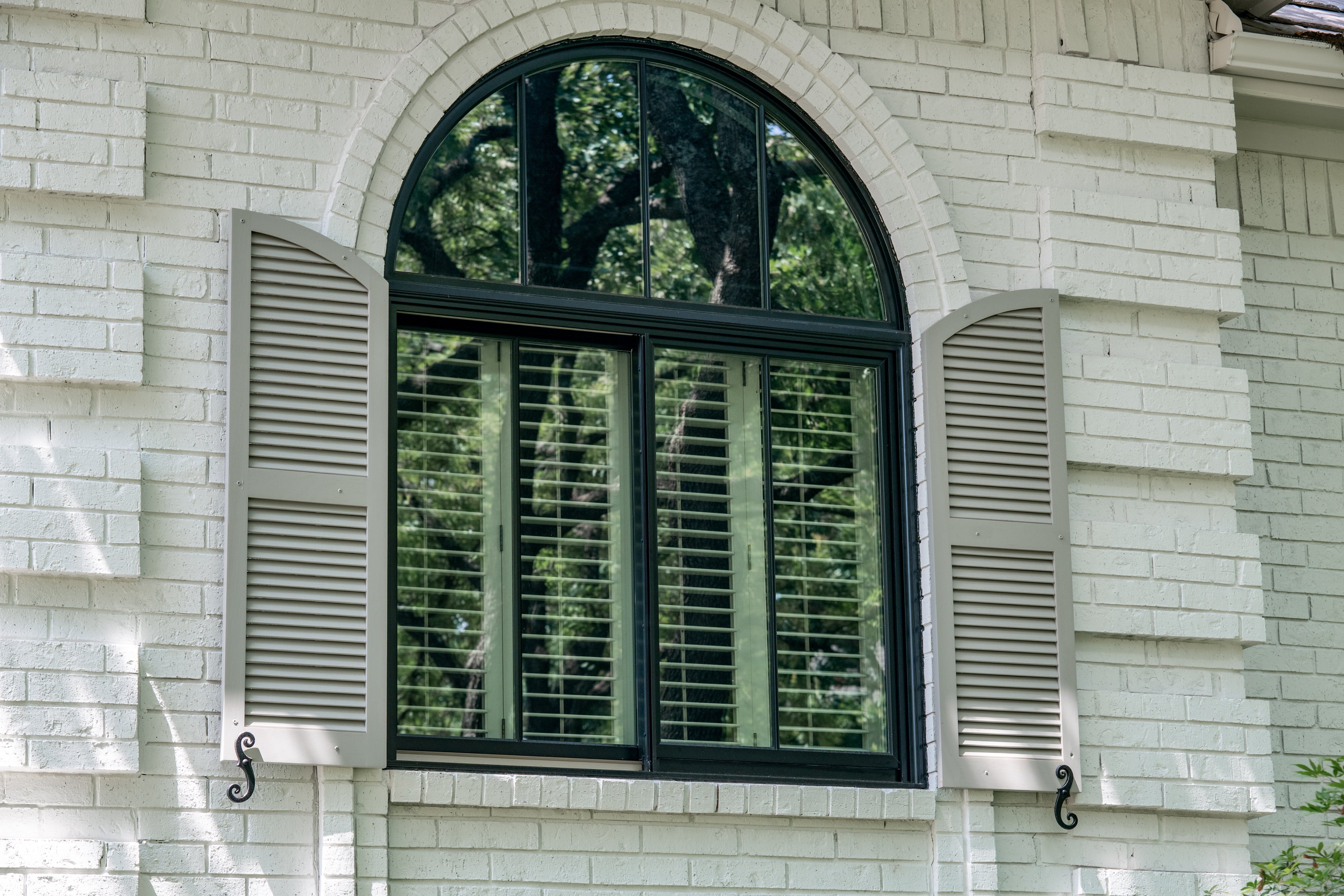 half round window over twin vertical sliders