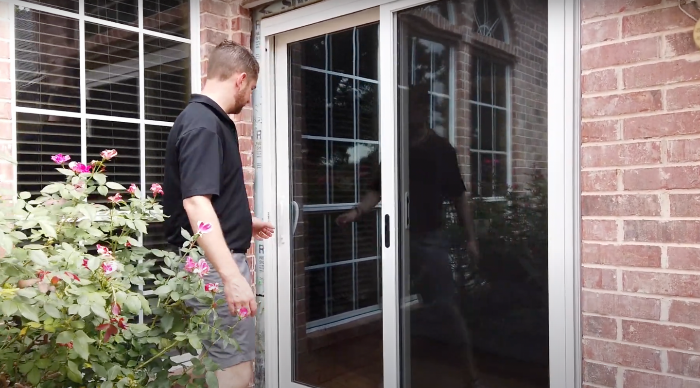 Photo of Brennan rep opening a sliding ProVia patio door. Photo by Brennan.