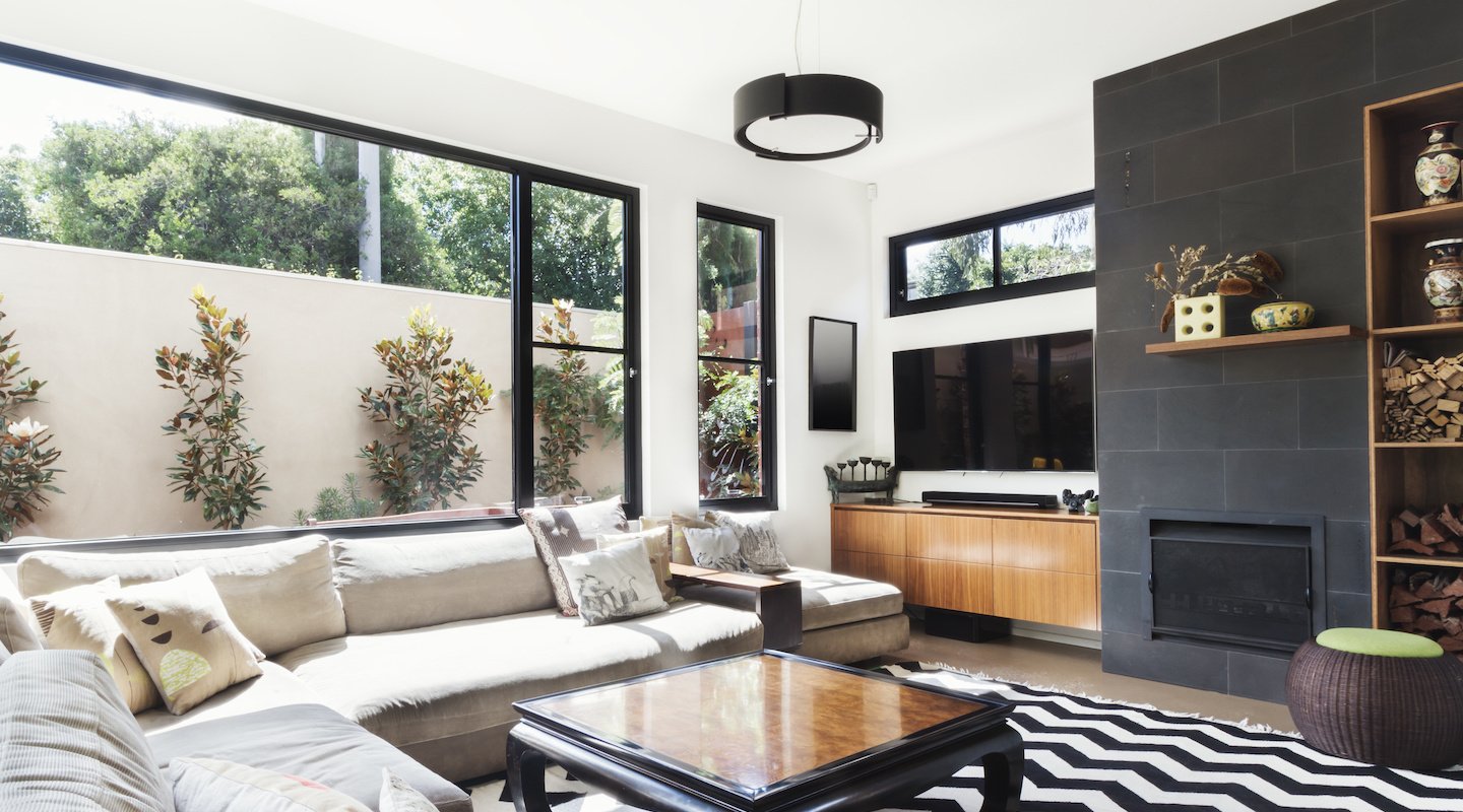 Living room with large contemporary windows. Photo from Adobe Stock.