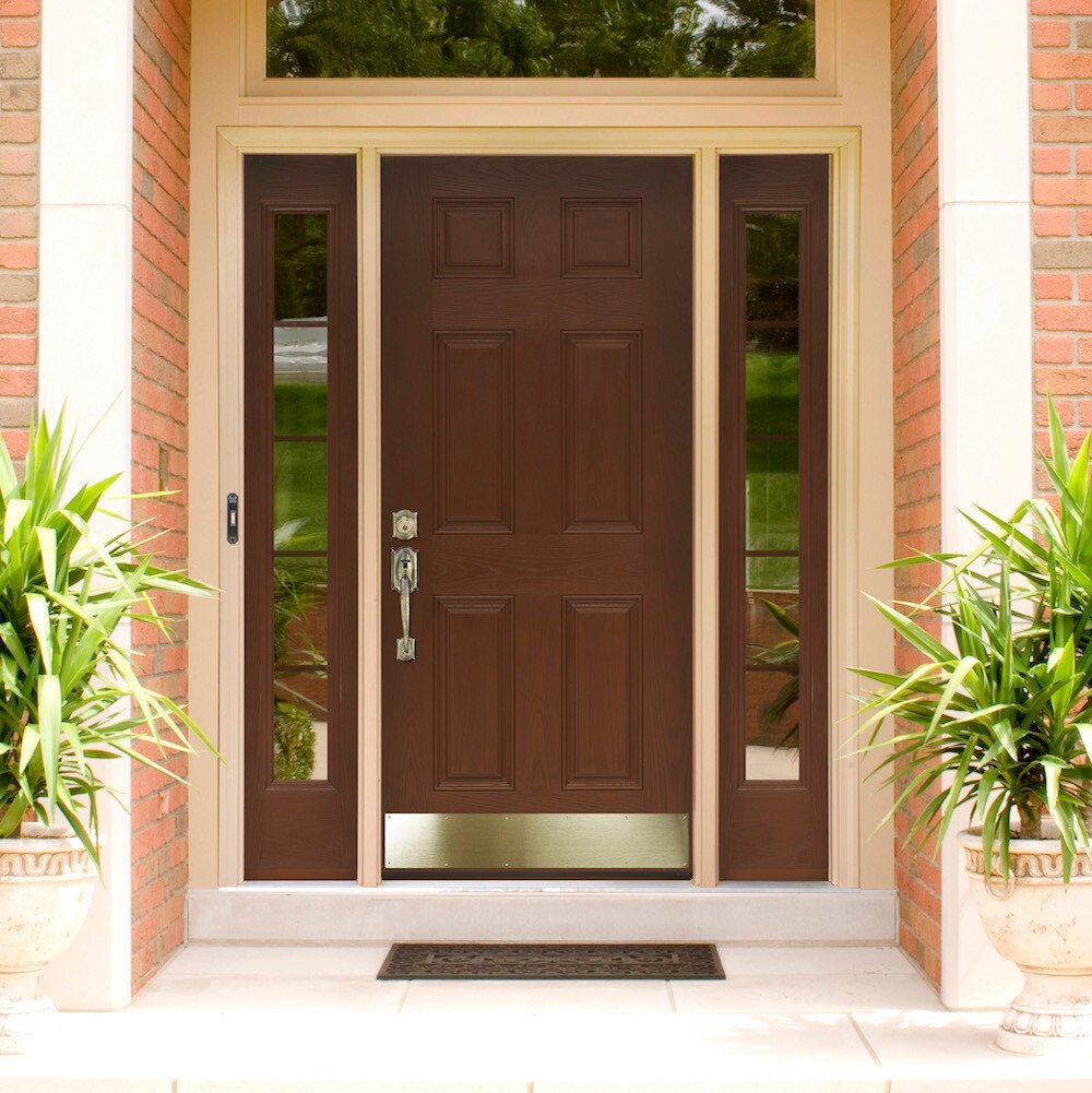 Brown fiberglass door with brass hardware and kickplate, left and right sidelites and transom.