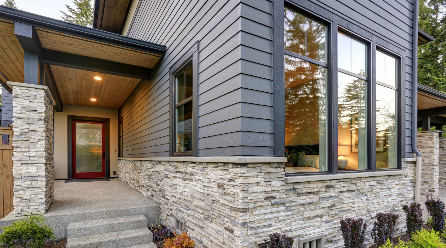 House with matching trim colors around the windows and doors. Photo from Adobe Stock.