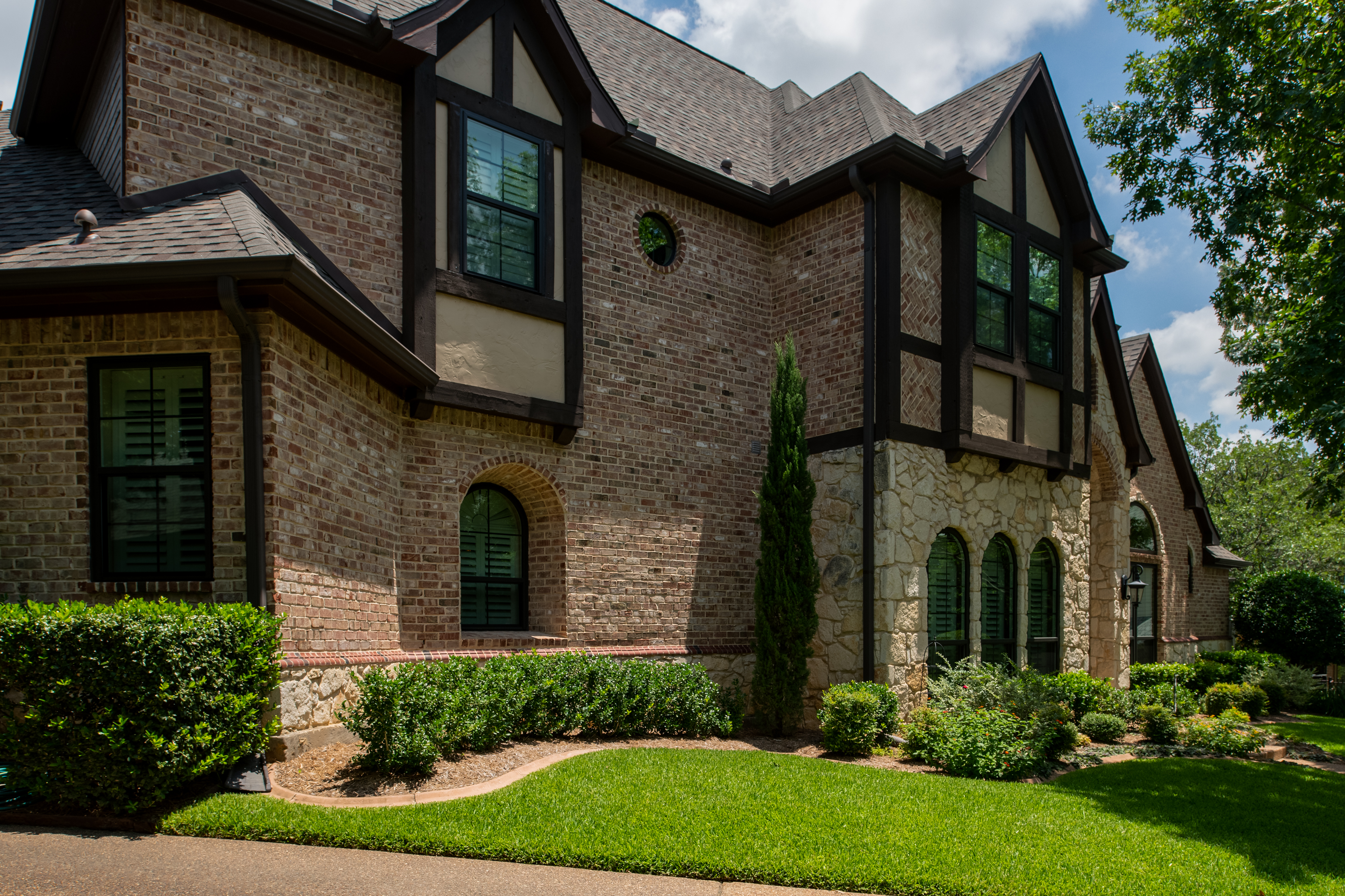 Windows Shown: Black Vinyl Brennan Traditions Windows – Double-Hung and Speciality Shapes