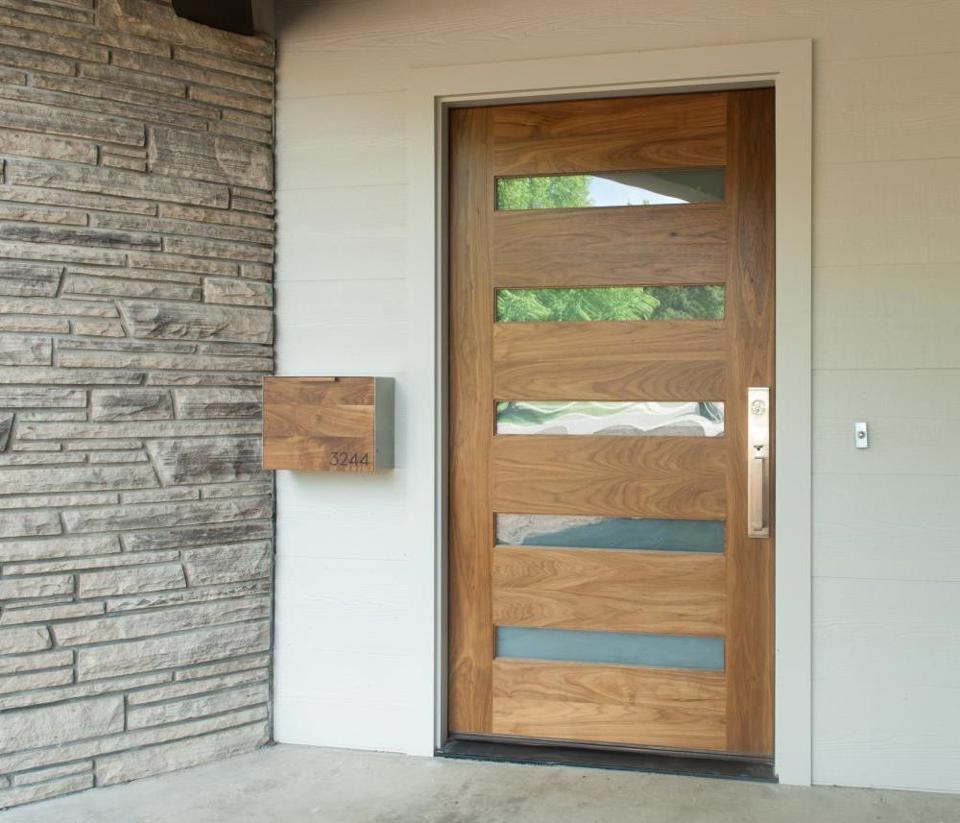 Oak door with alternating tall wood and short glass panels.