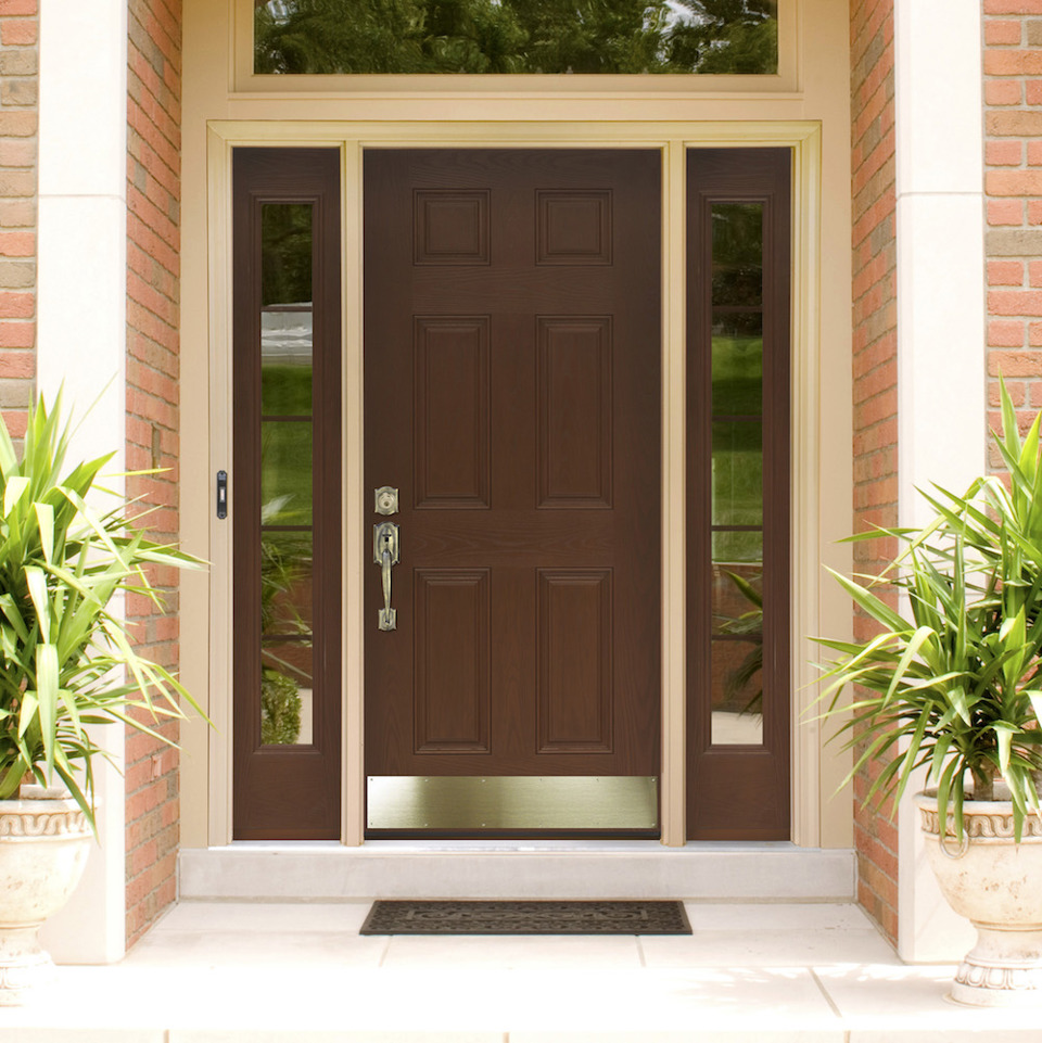 Brown fiberglass door with brass hardware and kickplate, left and right sidelites and transom.