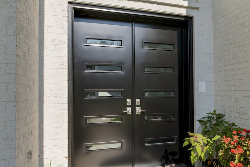 Front entry steel black front doors with glass slots and nickel hardware.