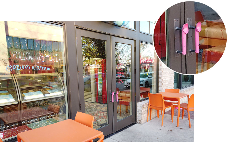 Storefront for Azucar Ice Cream shop in Bishop Arts District. Close up of pink ice cream scoop door handles.