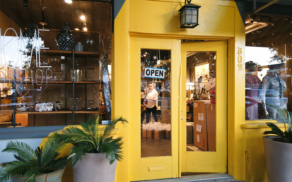 Home on Bishop storefront with bright yellow french doors, located in Bishop Arts District.