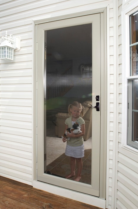 ProVia Duraguard storm door with girl behind closed door.