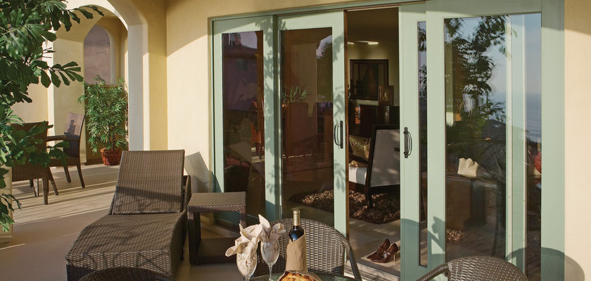 Aluminum exterior patio doors with light green finish from Andersen.
