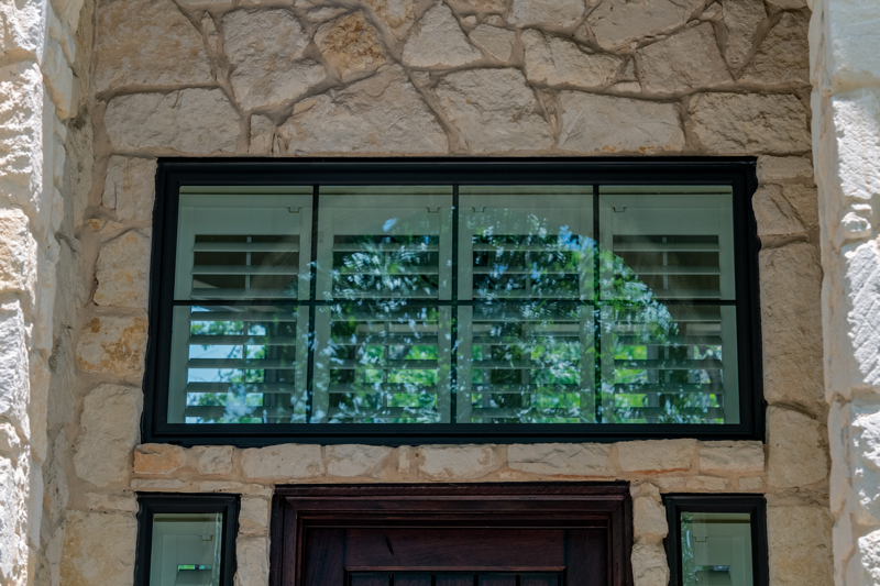 Bronze transom picture window with grids