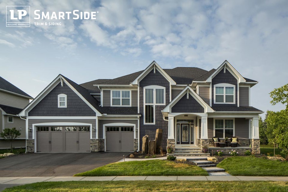 Navy blue, gray, and white suburban house with 3-car garage