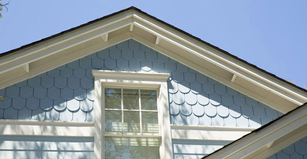 Round-edge (scallop) siding on gable around window.