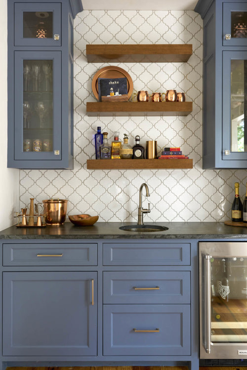 blue cabinets with gold hardware and dark countertop