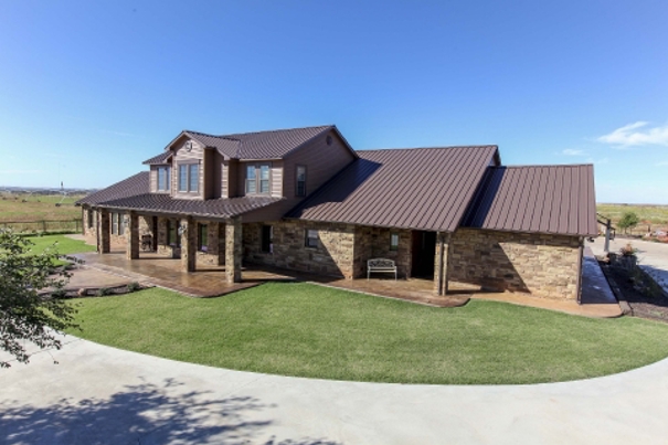 R Panel metal roof on a stone facade home.