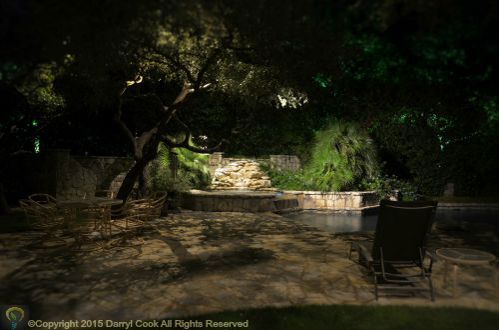 LED lighting over pool waterfall.