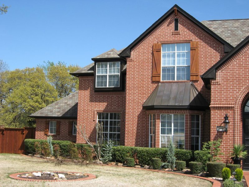 white-builder-grade-windows-with-red-brick