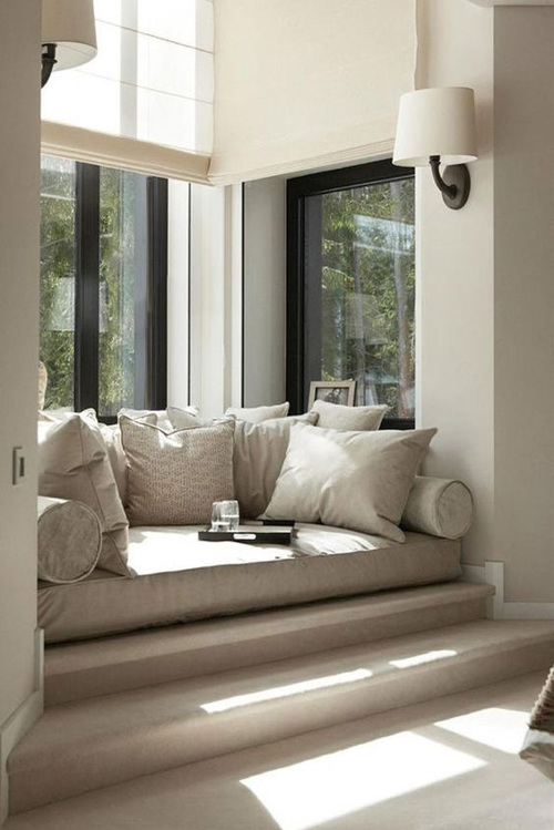 Pillows of all shapes and sizes fill this reading nook making it the perfect hibernation spot as well.