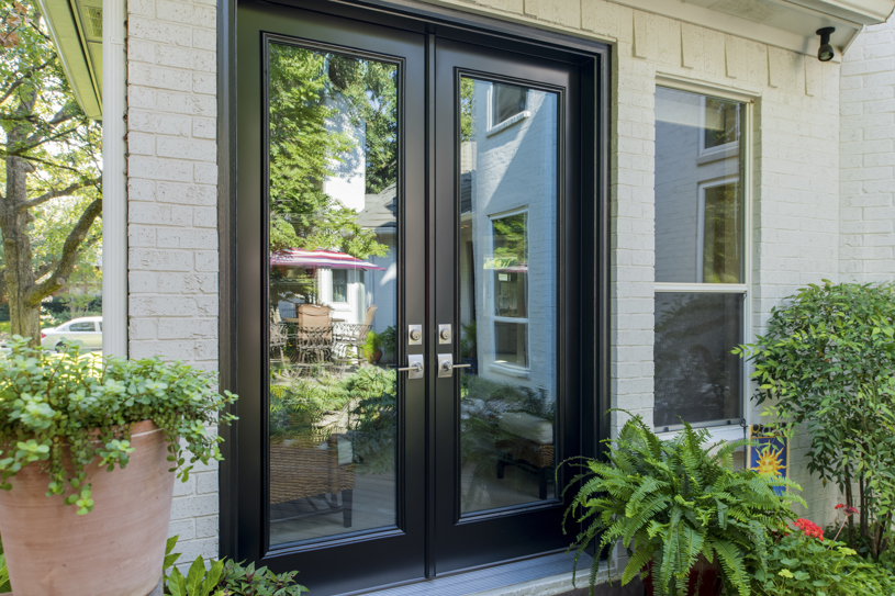 Exterior of house with black french doors.