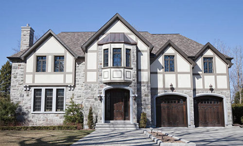 Tudor Style house with dark wood doors.