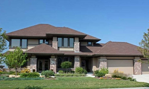 Example of a Prairie Style House with picture windows and a mixed facade.