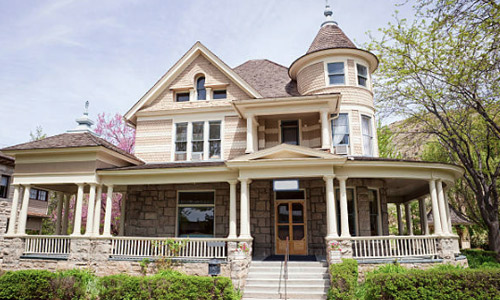 Example of a Victorian or Queen Anne style house with a mixed material facade.