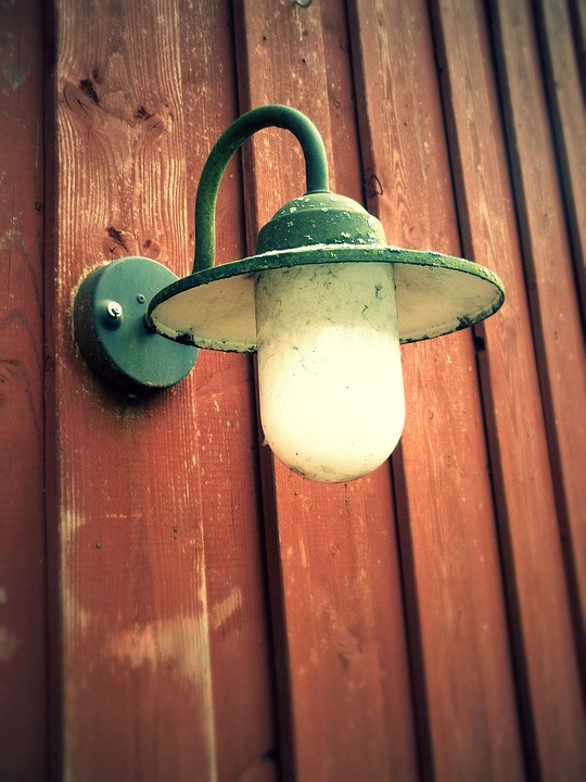 Vintage lighting on a wooden wall.