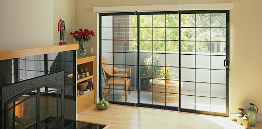 Interior view of Brennan installed three module black aluminum patio doors with grids.