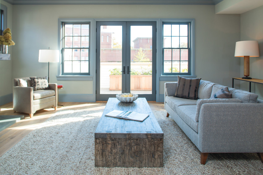 Photo of Andersen E-Series windows in Dove Gray finish. The windows blend in nicely in this cool tone living room.