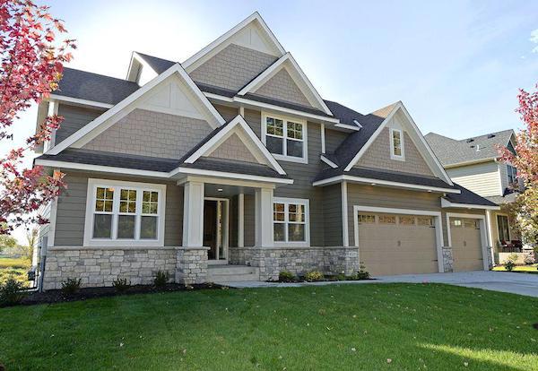 Modern craftsman style house with staggered edge shingles in gables.