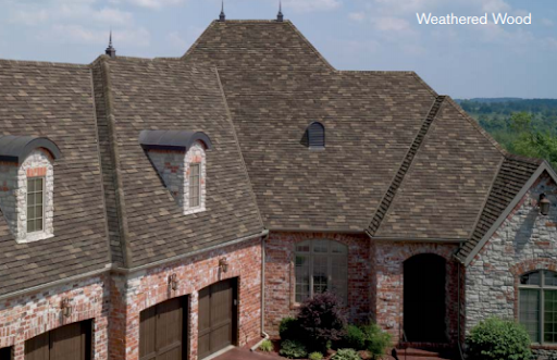 A red brick and stone french eclectic home with a new tamko heritage woodgate asphalt shingle roof.