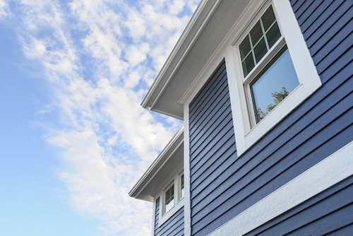 Blue James Hardie lap siding with white trim on a two story house