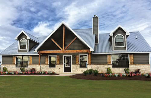House with wood accents, stone, and shingle siding.