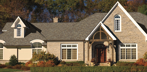 Neo-french home with mixed material facade and wood accents with Camelot II roofing shingles.