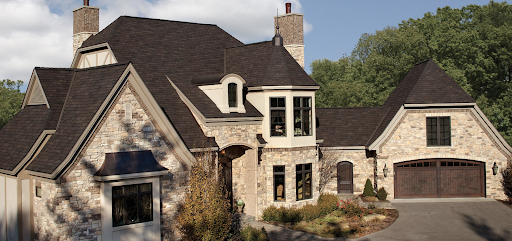 Large neo-french mansion with dark Woodland Designer Roofing Shingles.