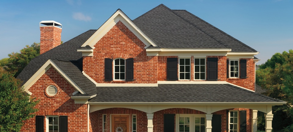 A large red brick home with charcoal GAF Timberline Armorshield asphalt shingles.