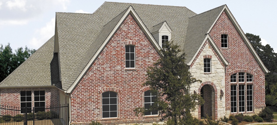 GAF Timberline Cool Series on a deep red brick home.