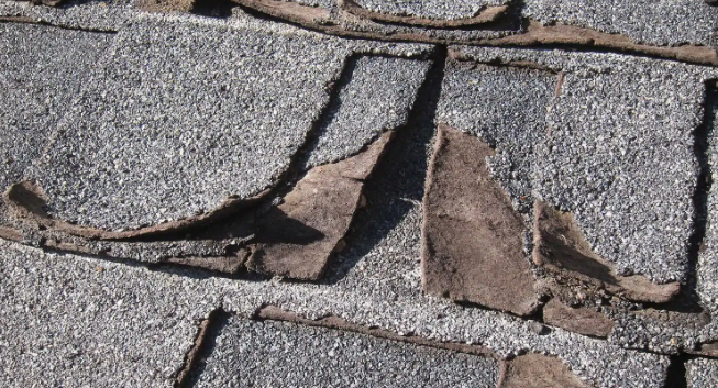 asphalt shingles with missing granules.